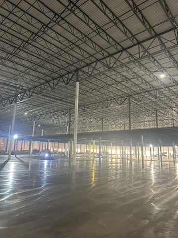 B&B Concrete Placement Inc workers lay a concrete foundation inside a new Amazon fulfillment center in Romulus Michigan