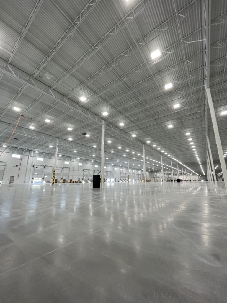 Concrete installation at a new construction site in Michigan with two concrete mixing trucks