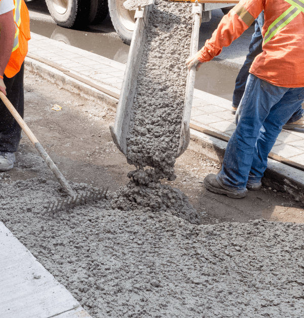 CAT backhoes digging or cleaning a flat ground surface to prep it for concrete