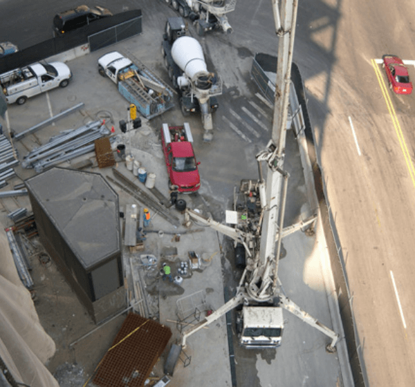 B&B Concrete employees/contractors at a construction site; there are many trucks with various tools in this picture